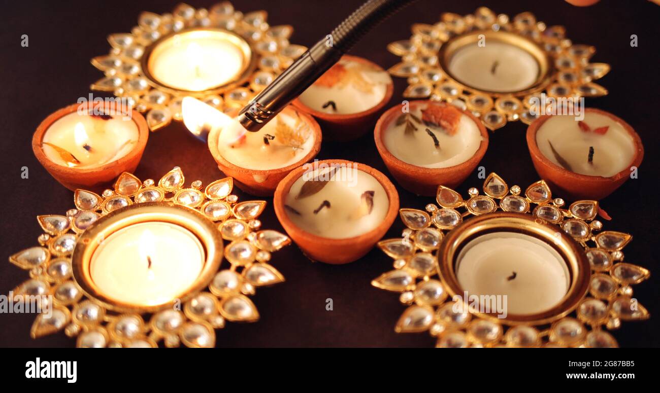 Closeup shot of decorative Diwali candles being lit Stock Photo - Alamy