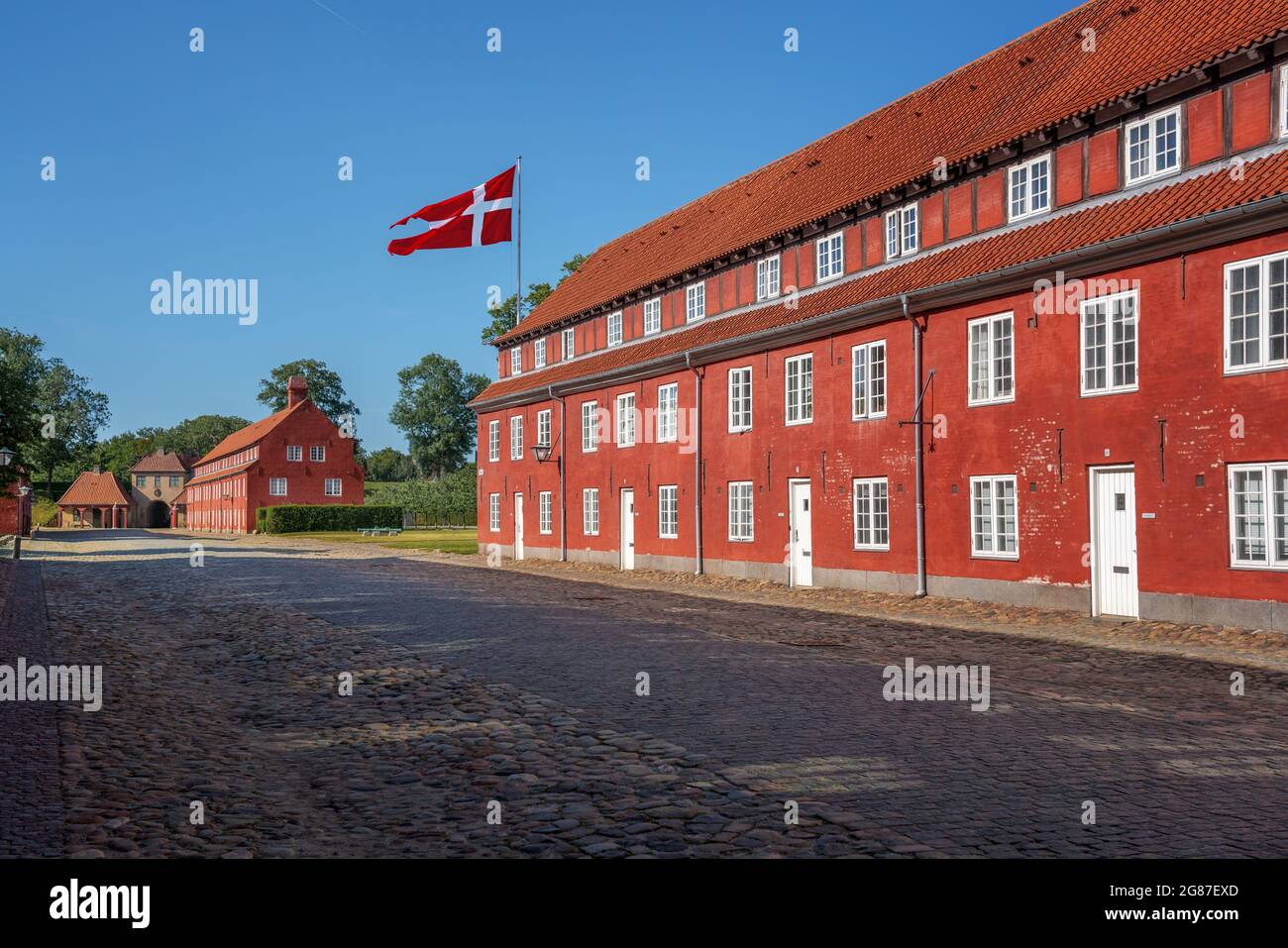Kastellet fortress buildings (The Citadel) with the flag of Denmark - Copenhagen, Denmark Stock Photo