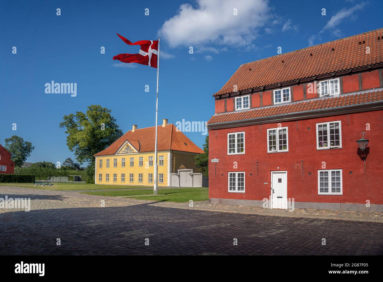 Kastellet fortress buildings and the Commander House with the flag of Denmark - Copenhagen, Denmark Stock Photo