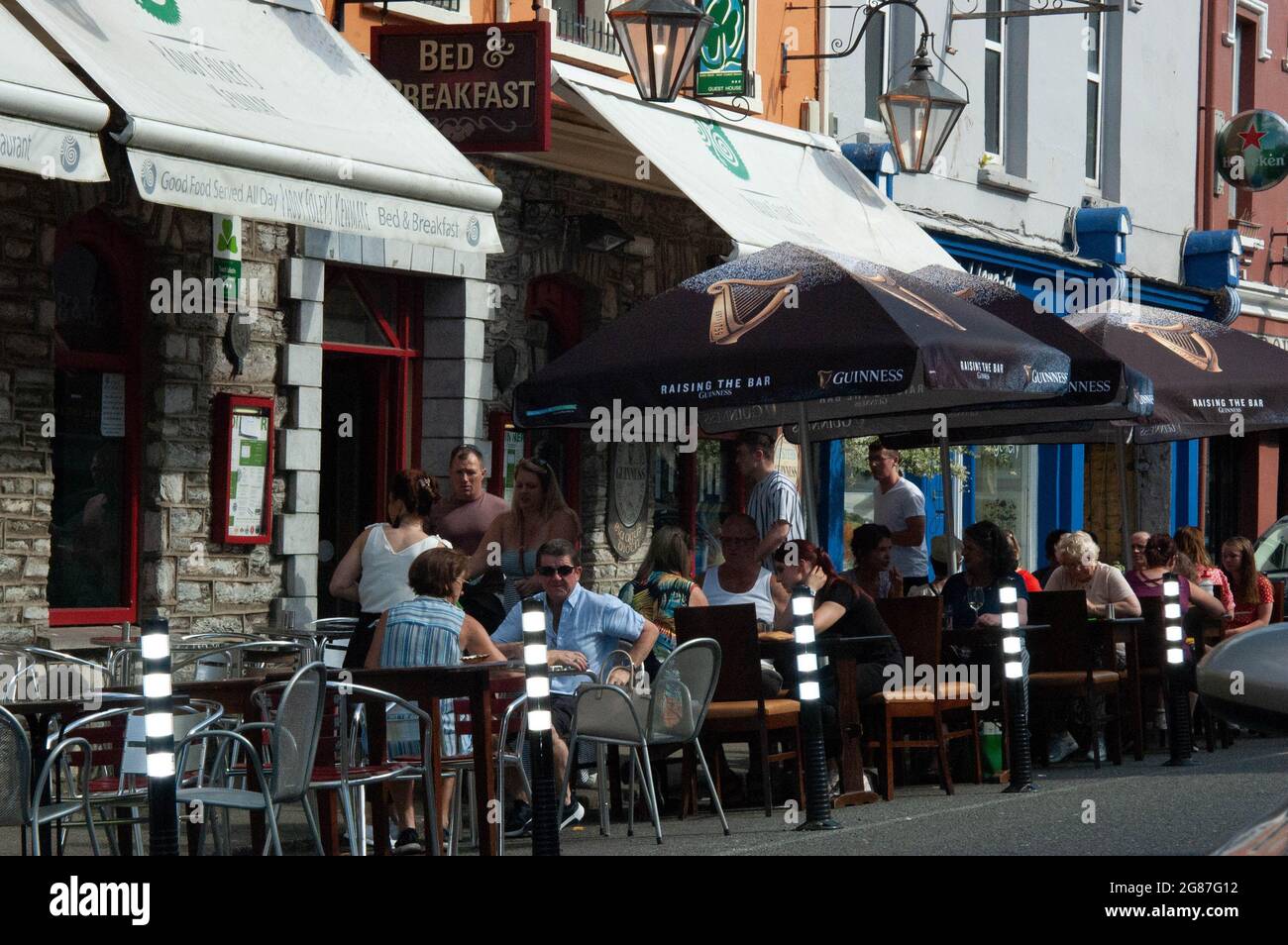 Kenmare Co. Kerry, Ireland, Saturday 17 July 2021; Weather conditions brought people out in their droves with Tempratures in some parts of the country, including Kenmare, hitting over 30 degrees Celcius. Many Bars and restraunt which are currently open under the revised guidelines ensured social distancing and sanitization protocols. Credit; ED/Alamy Live News Stock Photo