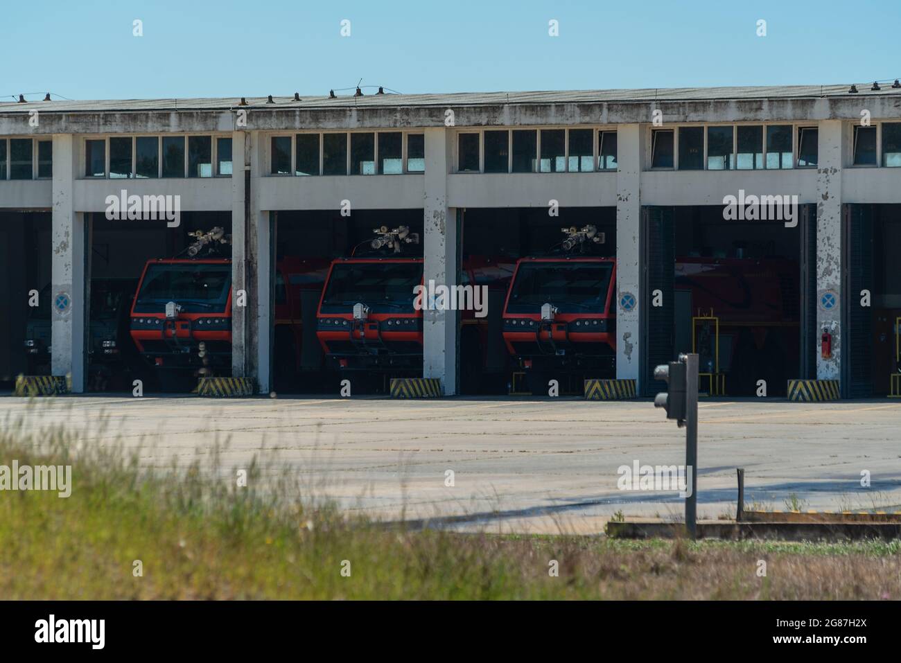 A group of fire trucks parked in the garage and ready to call, to help with a fire. Emergency service at the airport. Stock Photo