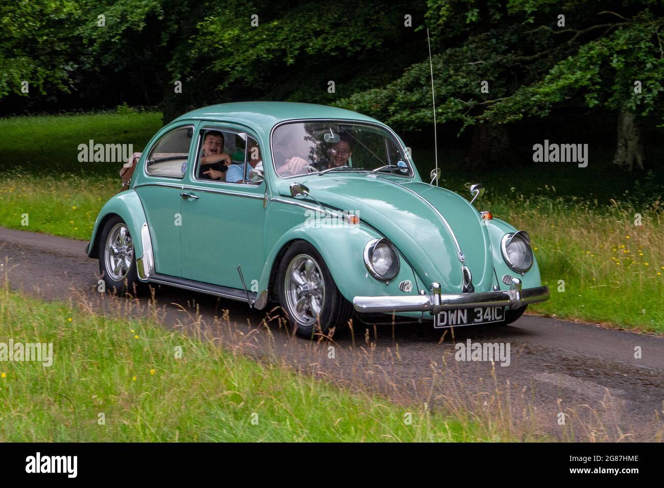 A 1965 60s green classic vintage Volkswagen Beetle 1200 Car at ‘The Cars the Star Show” in Holker Hall & Gardens, Grange-over-Sands, UK Stock Photo