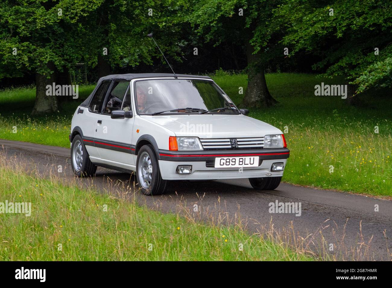 A 1990 90s white Peugeot 205 Cti Cabriolet Petrol at ‘The Cars the Star Show” in Holker Hall & Gardens, Grange-over-Sands, UK Stock Photo