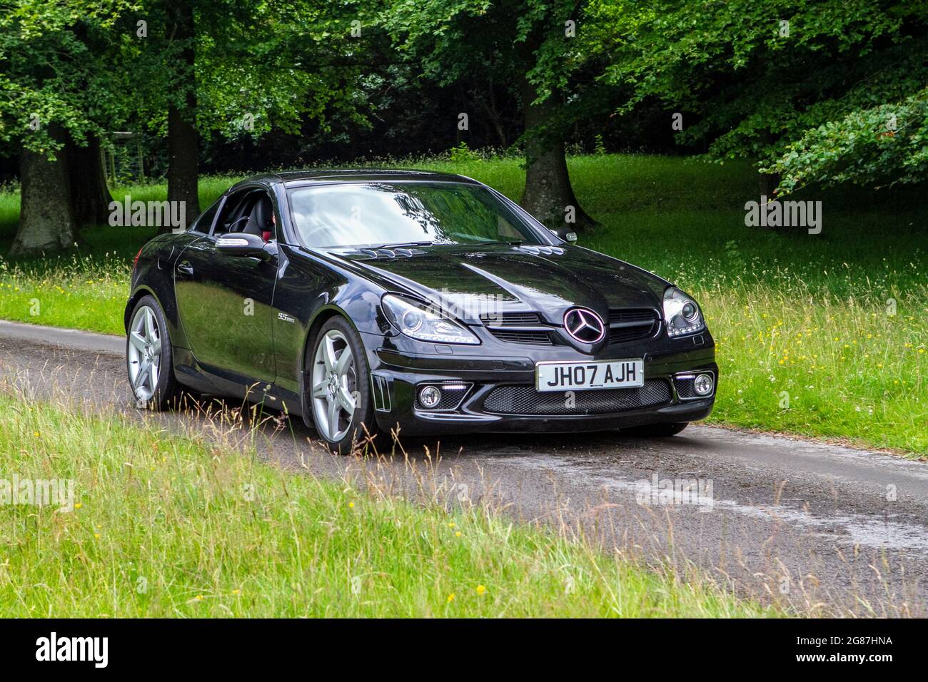 A Mercedes Slk 55 Amg Auto Black Car Roadster at ‘The Cars the Star Show” in Holker Hall & Gardens, Grange-over-Sands, UK Stock Photo