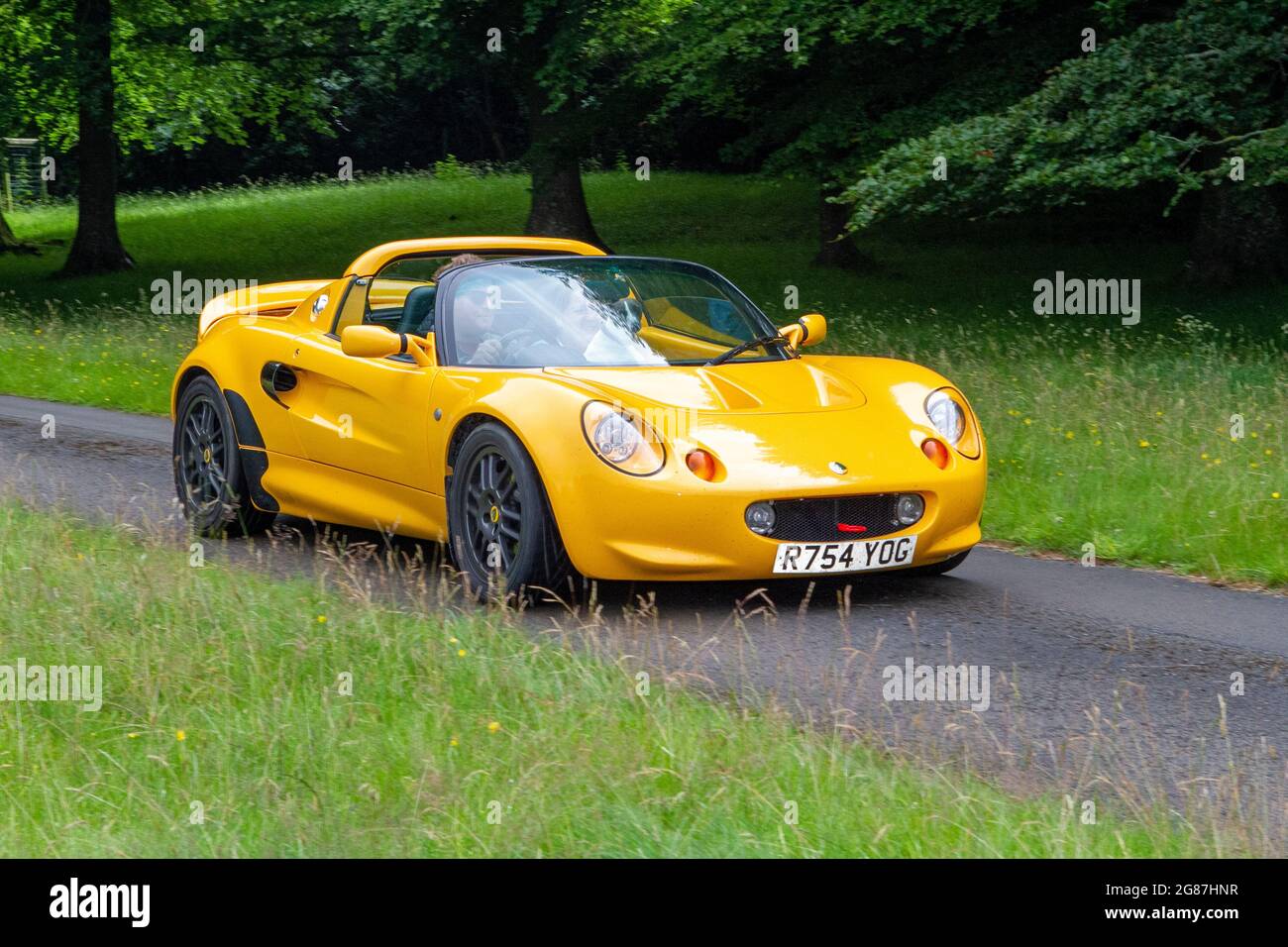 1998 90s yellow Lotus Elise 5 speed manual at ‘The Cars the Star Show” in Holker Hall & Gardens, Grange-over-Sands, UK Stock Photo