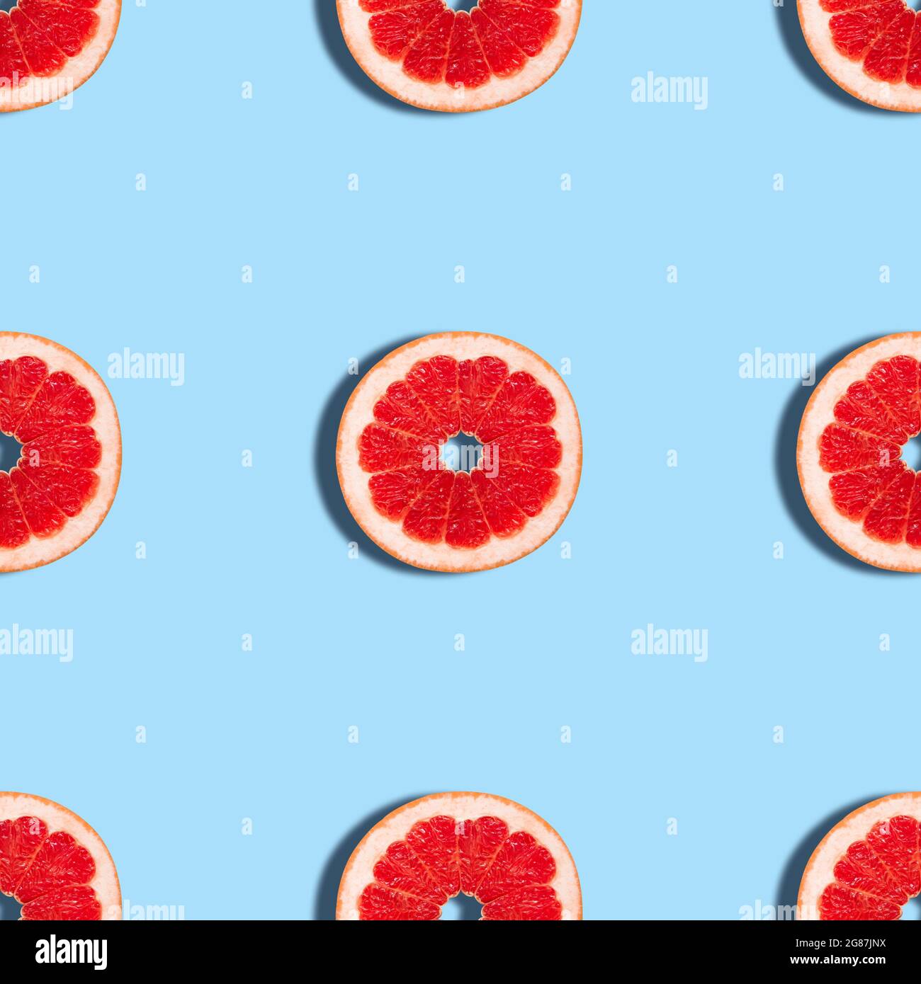 Grapefruit seamless pattern on a blue background. Tropical abstract ...