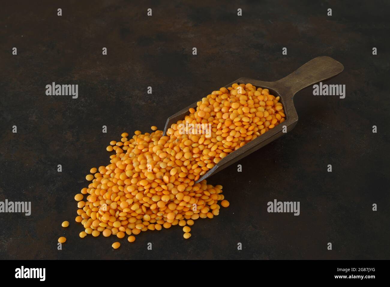 Heap of red lentil with wooden spoon. Healthy eating containing natural