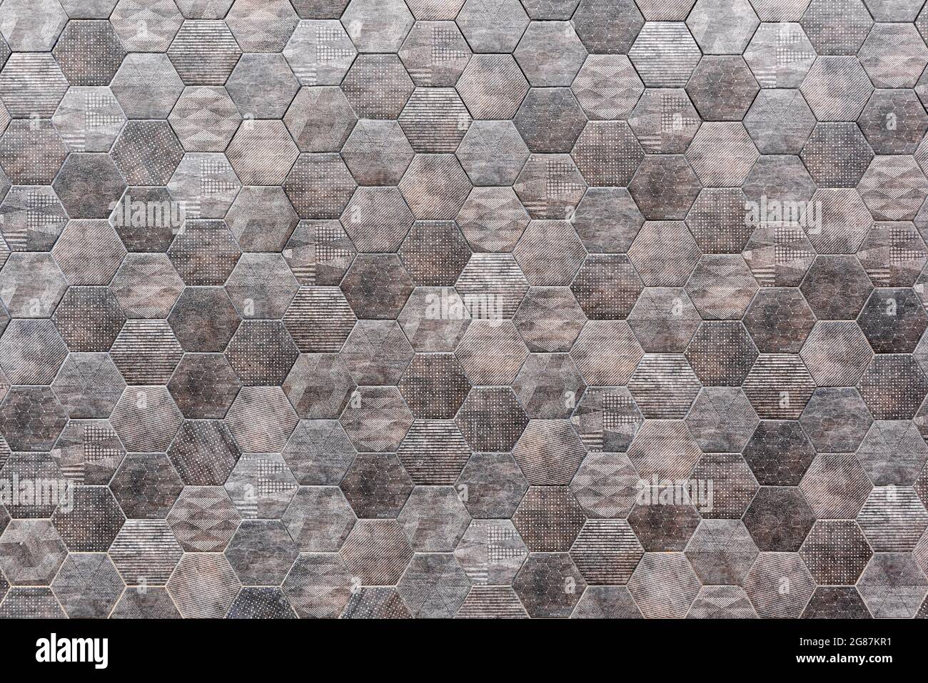 Hexagonal tile wall, gray hexagonal tile, outdoor wall, space for text. Stock Photo