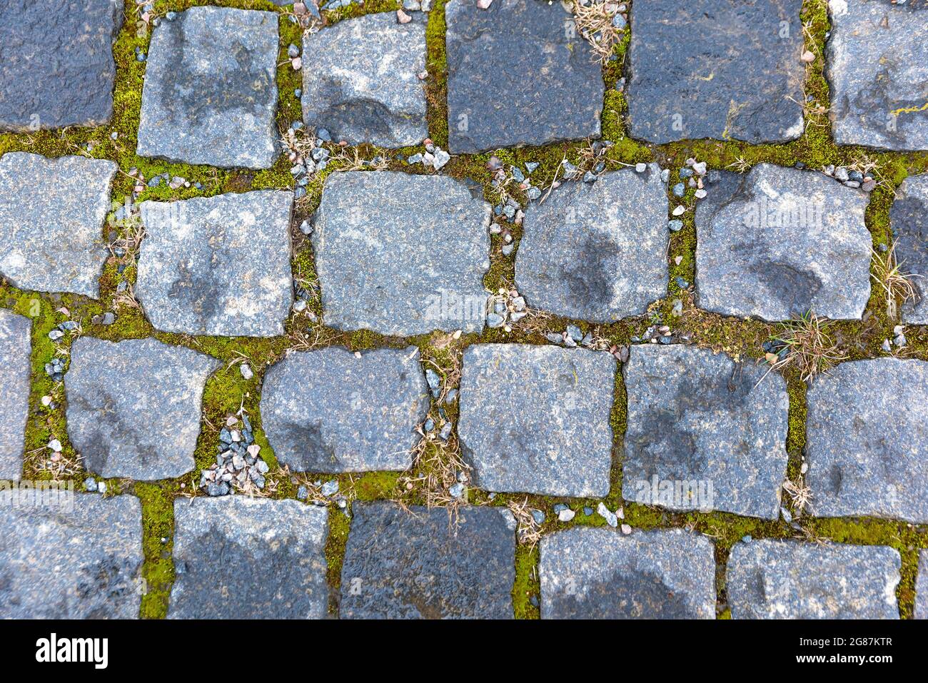 Old road paved with granite stones, top view Stock Photo