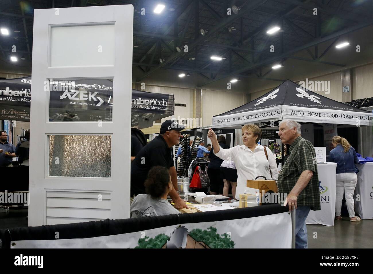 Houma, USA. 17th July, 2021. Visitors talk to an exhibitor during the annual Bayou Home Show and Cannata's Festival of Food in Houma, Louisiana, the United States, on July 17, 2021. The home show and festival of food is held on Saturday and Sunday in Houma, showcasing the latest products and services in kitchens, bathrooms, siding and solar products. Credit: Lan Wei/Xinhua/Alamy Live News Stock Photo
