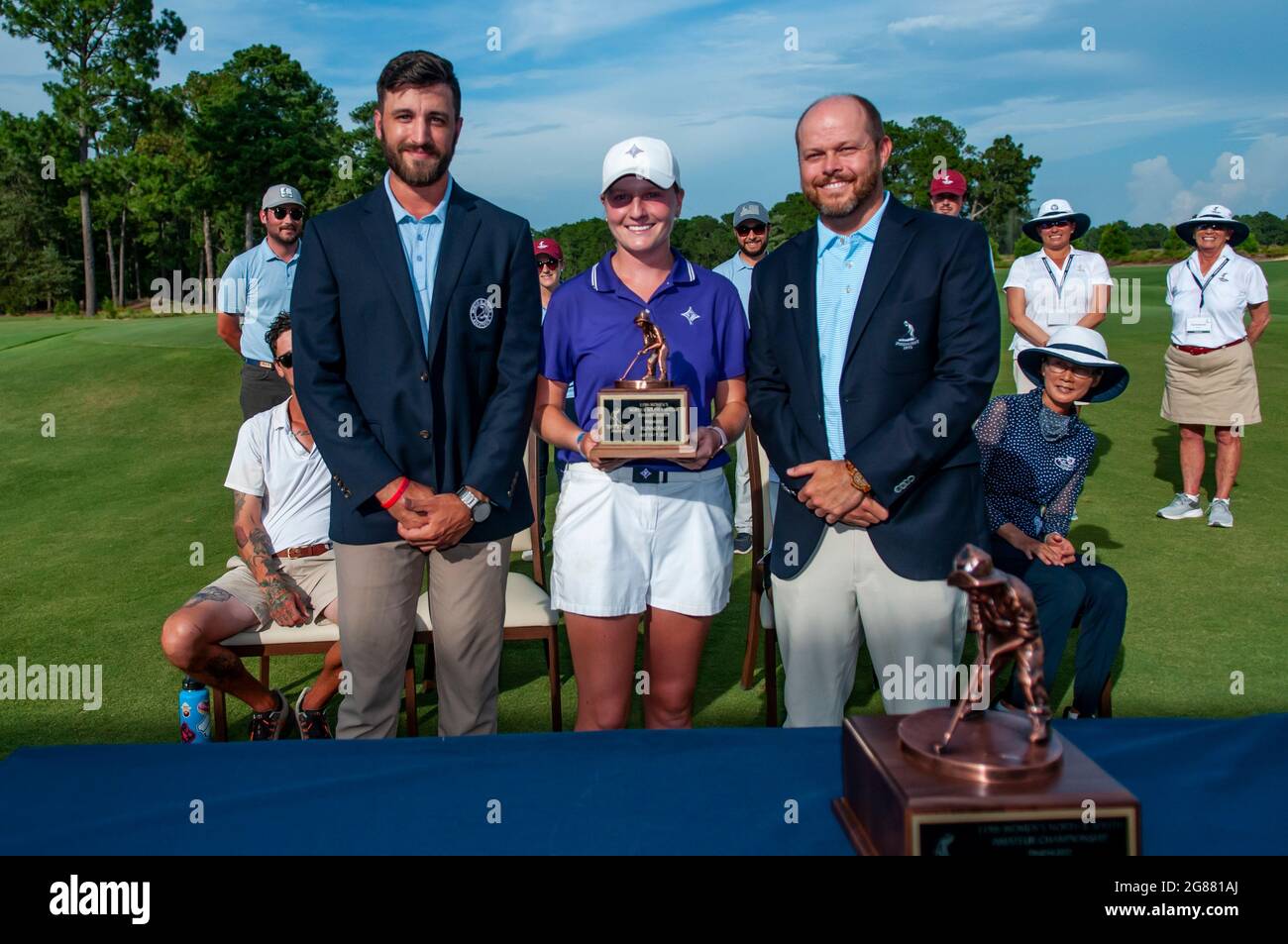 Pinehurst, North Carolina, USA. 17th July, 2021. ANNA MORGAN, of Spartanburg, South Carolina and golfer at Furman University, poses with the runner-up Putter Boy trophy flanked by MATT NUNEZ, left, and BEN BRIDGERS after the Final Round at the 119th North & South WomenÃs Amateur Championship, July 17, 2021, at the Pinehurst Resort & Country ClubÃs Course No. 2 in the Village of Pinehurst, N.C. GINA KIM, of Durham, North Carolina and golfer at Duke University, won the match and the championship. (Credit Image: © Timothy L. Hale/ZUMA Press Wire) Stock Photo
