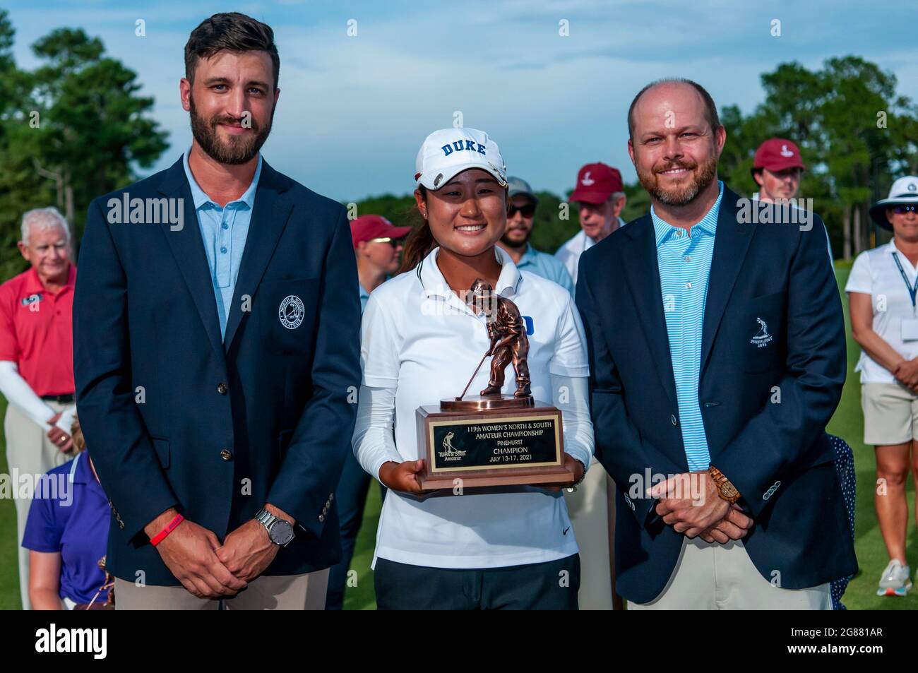 Pinehurst, North Carolina, USA. 17th July, 2021. GINA KIM, of Durham, North Carolina and golfer at Duke University, poses with the Putter Boy trophy flanked by MATT NUNEZ, left, and BEN BRIDGERS after the Final Round at the 119th North & South WomenÃs Amateur Championship, July 17, 2021, at the Pinehurst Resort & Country ClubÃs Course No. 2 in the Village of Pinehurst, N.C. Kim won the match and the championship defeating ANNA MORGAN, of Spartanburg, South Carolina and golfer at Furman University. (Credit Image: © Timothy L. Hale/ZUMA Press Wire) Stock Photo