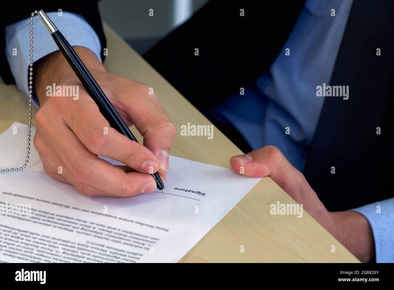 Job interviewer put a sign on the contract after being considered by the HR department. Stock Photo
