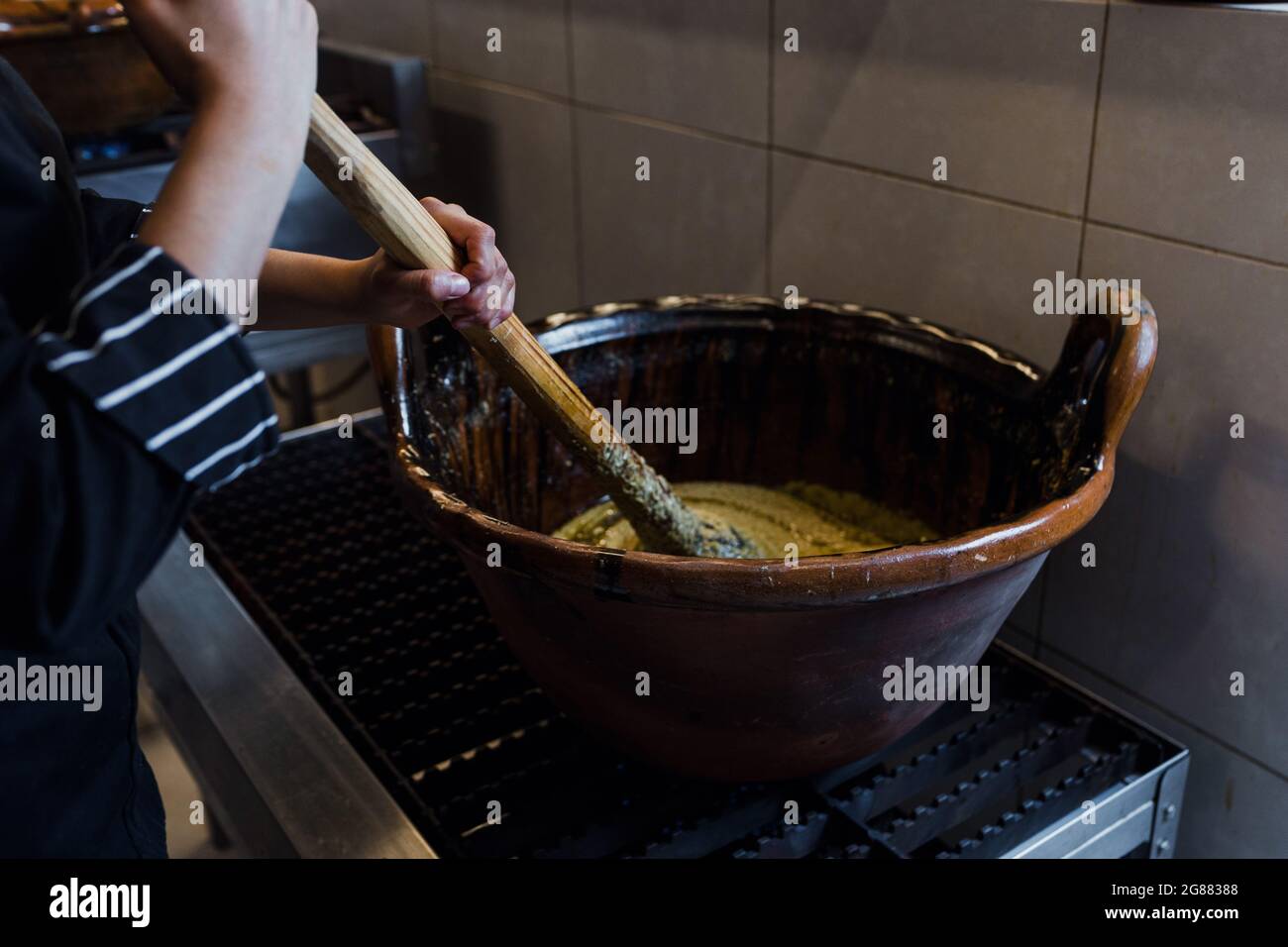 cooking Mexican Mole food in a traditional clay pot in Mexico Stock