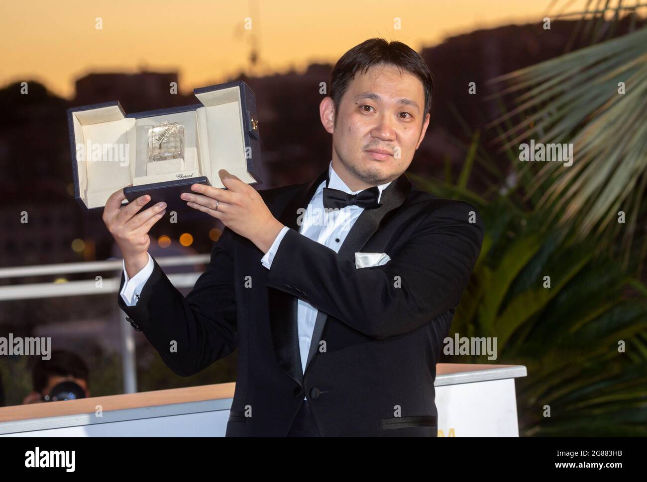 Ryusuke Hamaguchi poses with the 'Best Screenplay Award' for 'Drive my Car' during the 74th Annual Cannes Film Festival at Palais des Festivals in Cannes, France, on 17 July 2021. Stock Photo