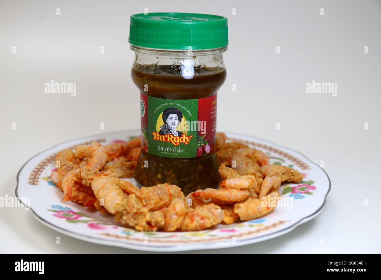 Photo of Indonesian chili sauce in a bottle with white background. Sambal Bu Rudy. Chili Package