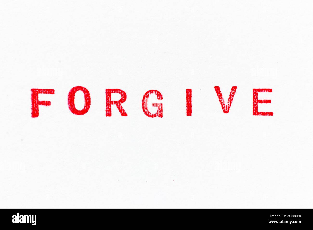 Red color ink rubber stamp in word forgive on white paper background Stock Photo