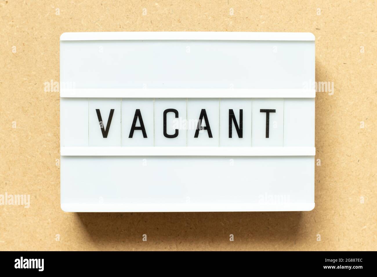 Lightbox with word vacant on wood background Stock Photo Alamy