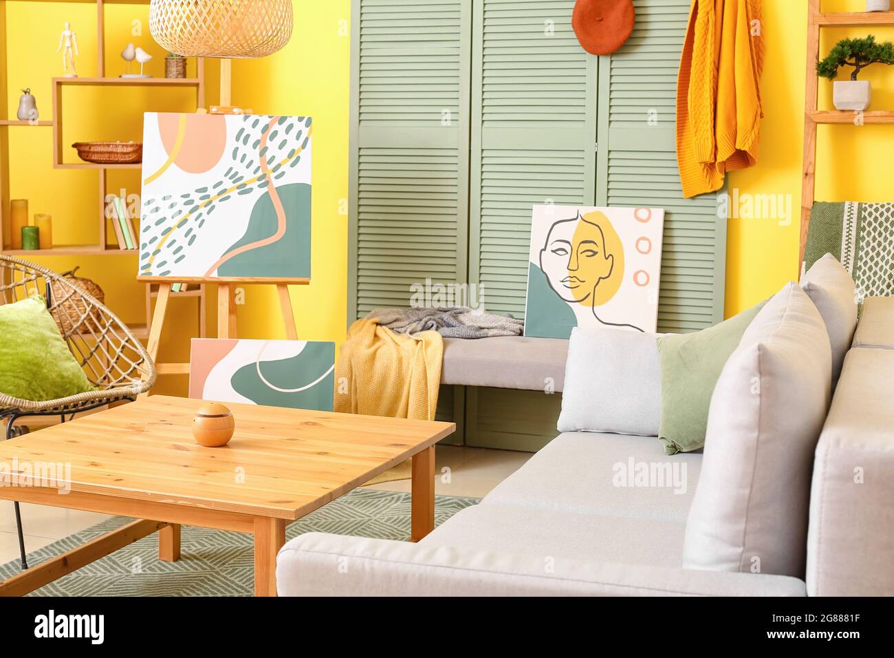 Interior of stylish living room with pictures Stock Photo - Alamy