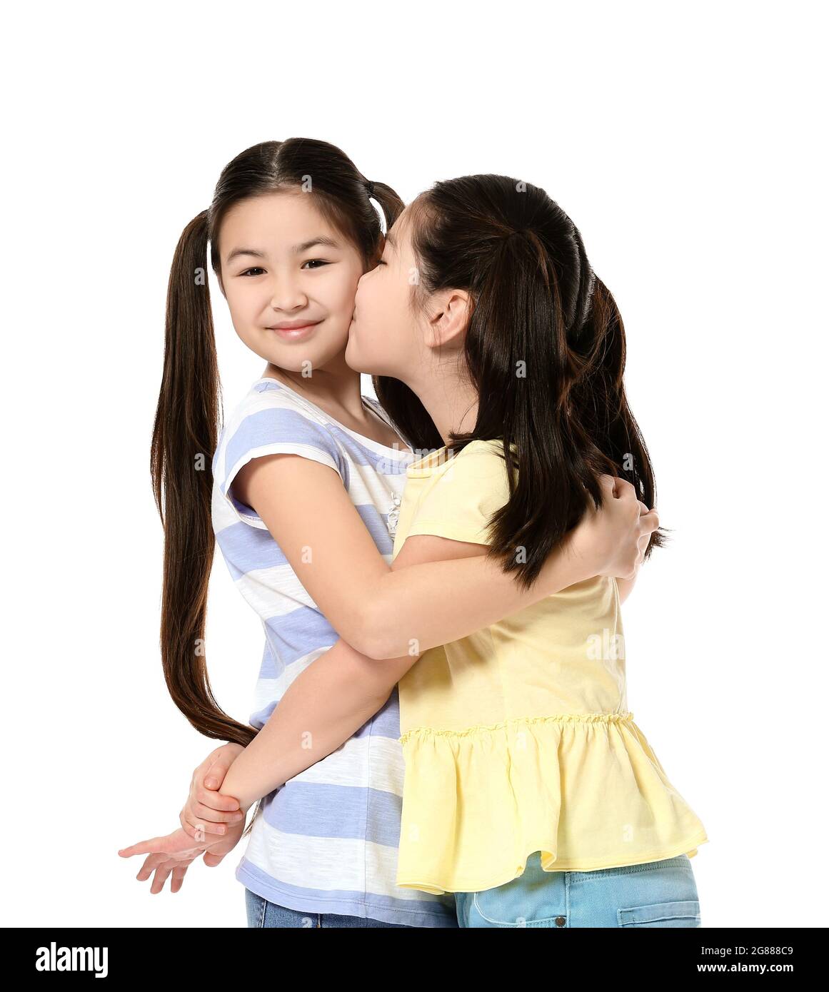 Cute Asian sisters on white background Stock Photo