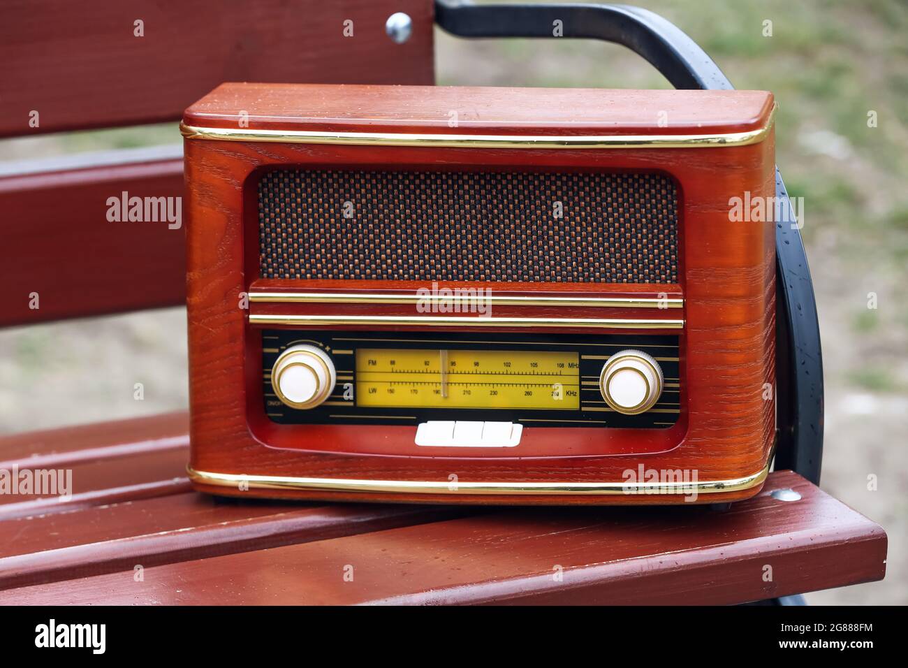 Retro radio receiver on bench outdoors, closeup Stock Photo - Alamy