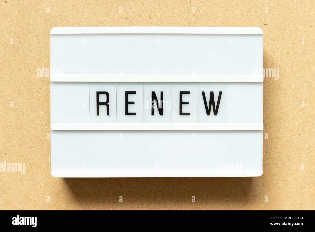 Lightbox with word renew on wood background Stock Photo