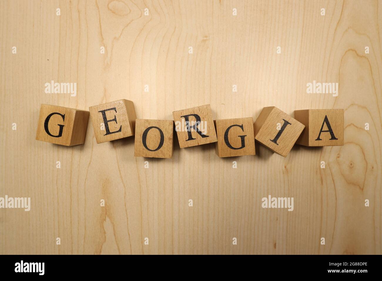 The word was created from wooden letter cubes. Cities and words