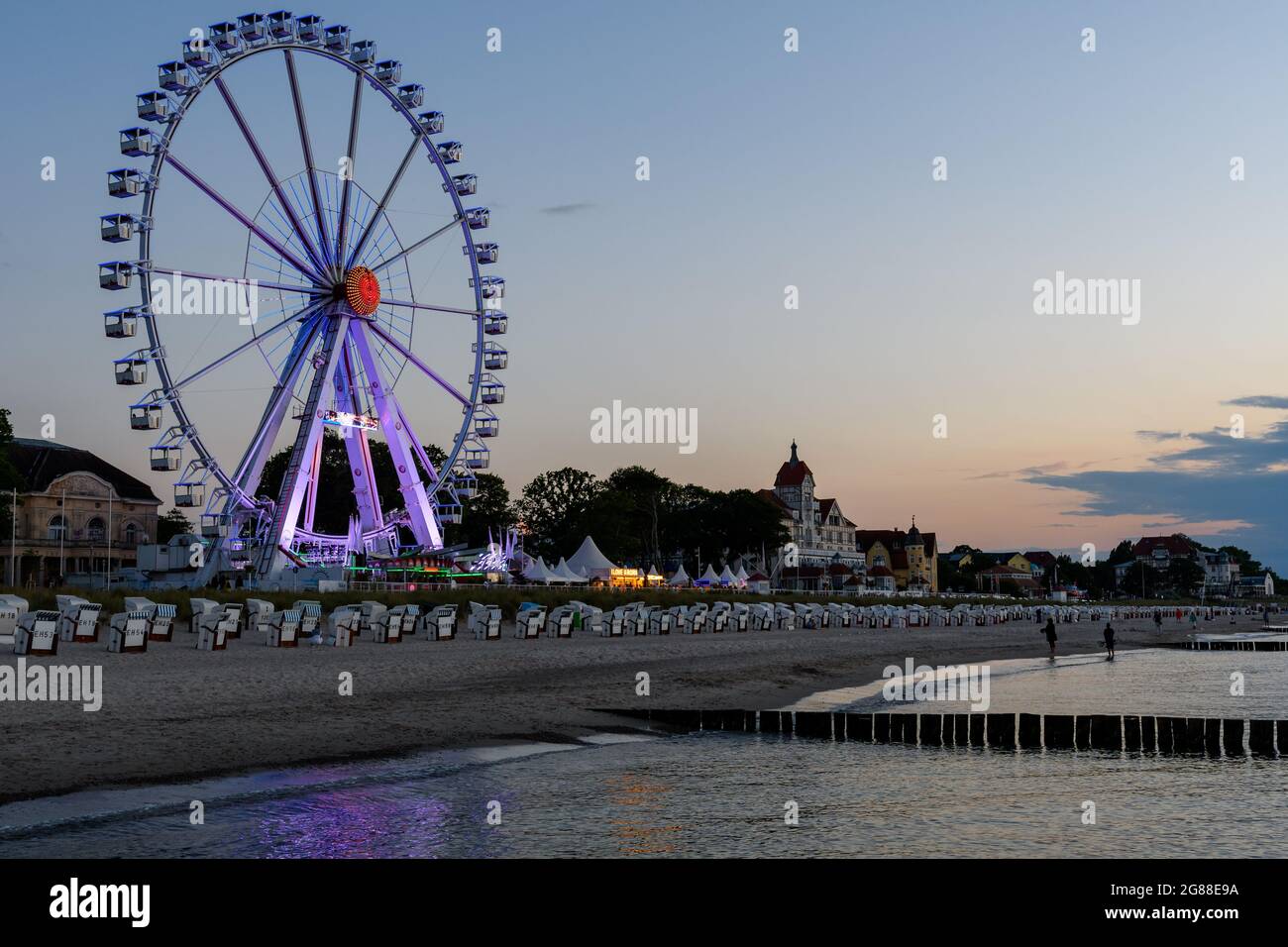 Promenade of Kuehlungsborn with a ferris wheel , Germany Stock Photo