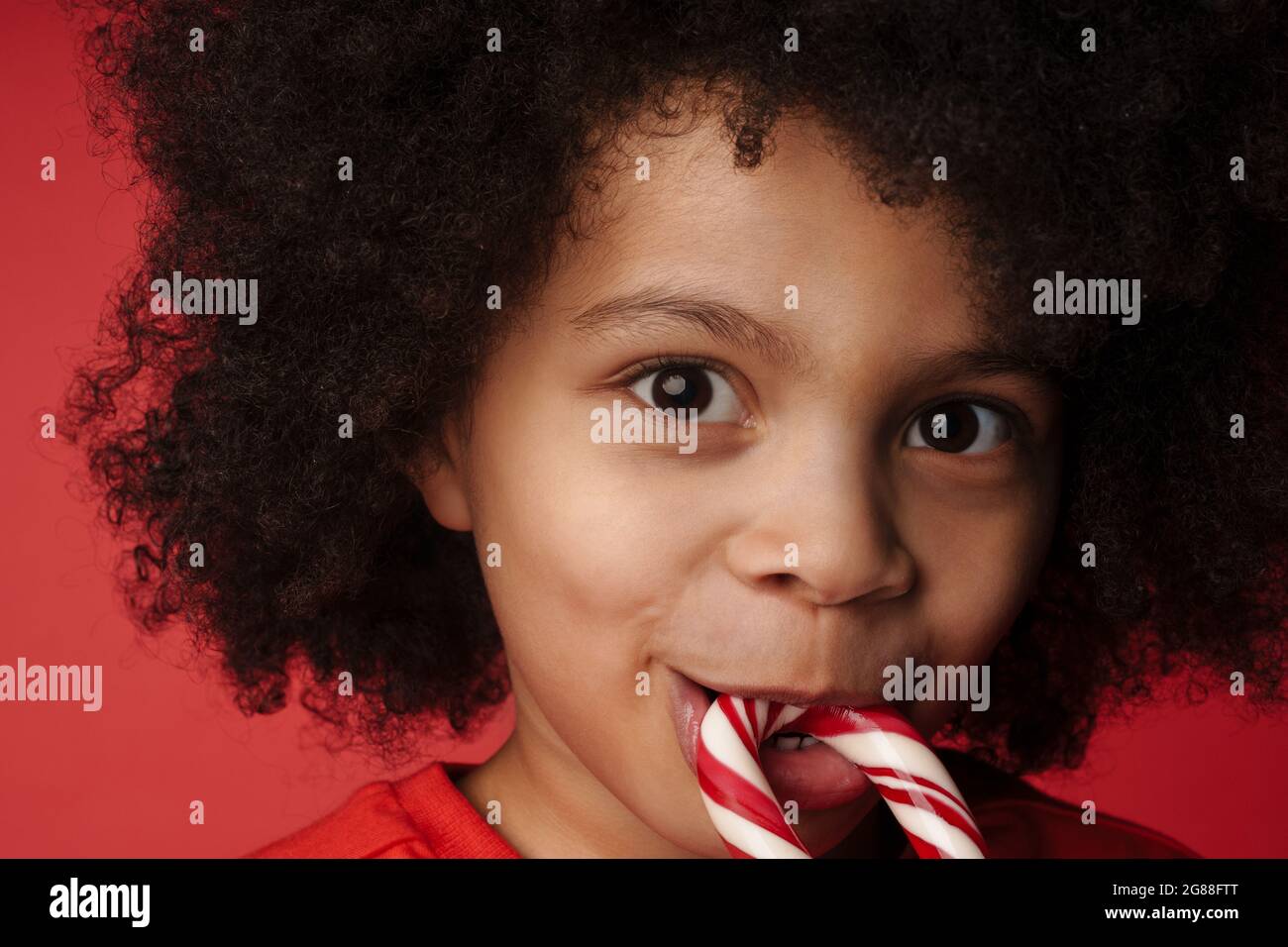 Child eating candy cane hires stock photography and images Alamy