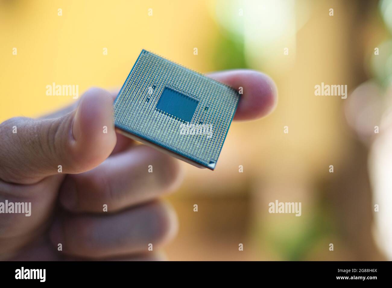 Man hand while hold a desktop pc cpu part,computer components chip Stock Photo