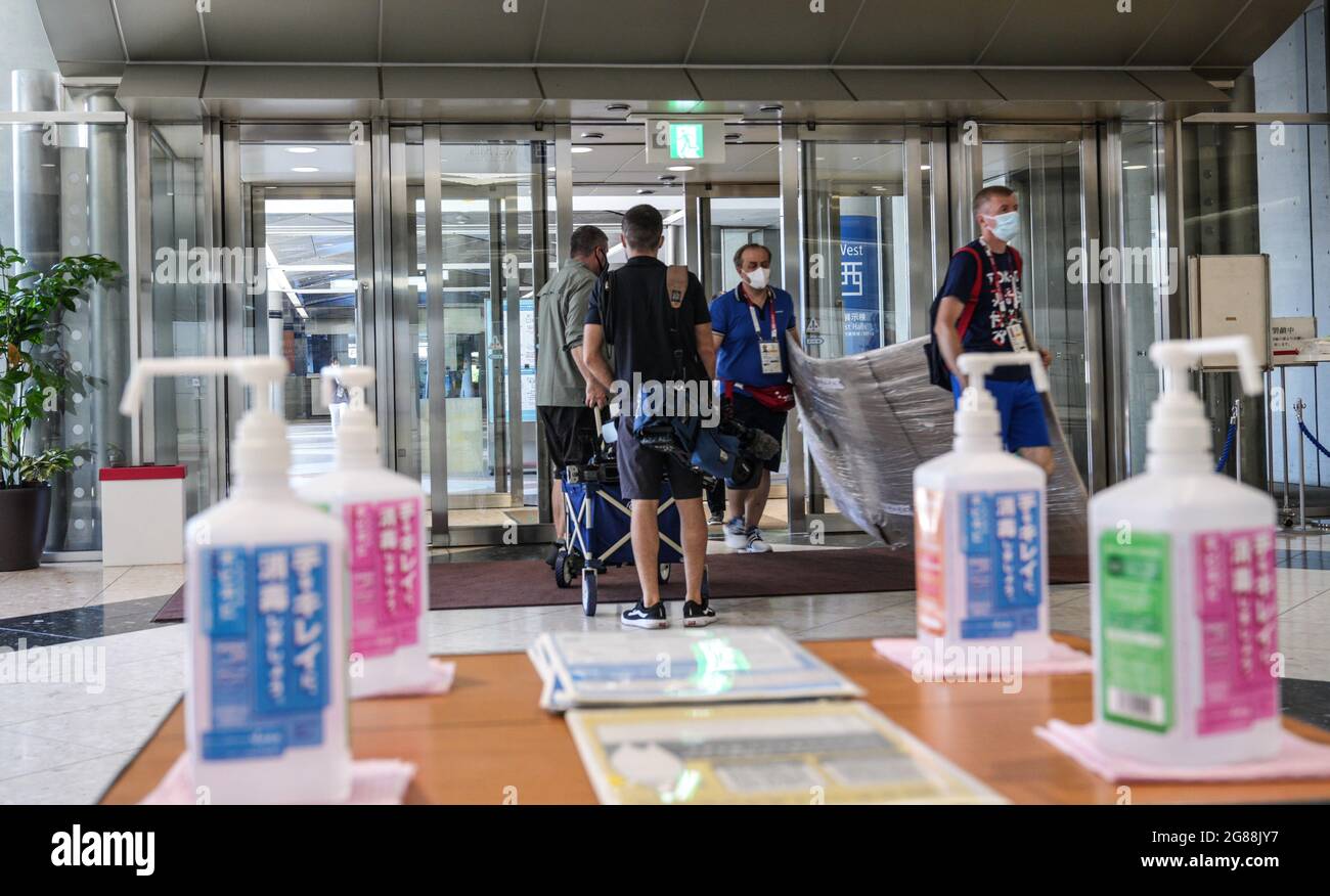 Tokyo, Japan. 18th July, 2021. Journalists carry equipments into the Main Press Center of Tokyo 2020 in Tokyo, Japan, July 18, 2021. Credit: Yang Lei/Xinhua/Alamy Live News Stock Photo