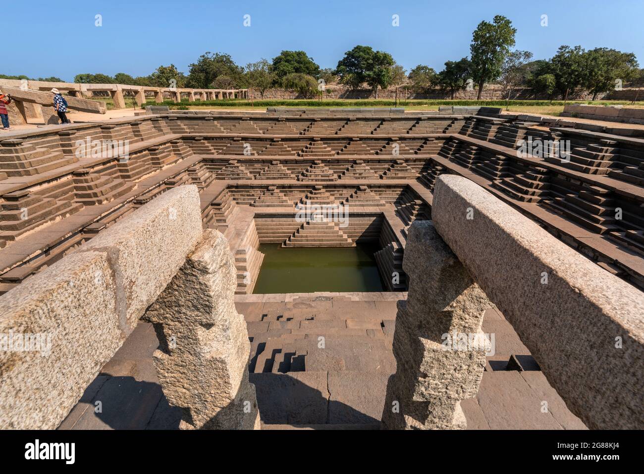 Hampi, Karnataka, India - January 14, 2020 : Symmetrical stepped square water tank (Stepwell) inside the Royal Enclosure at Hampi. Stock Photo