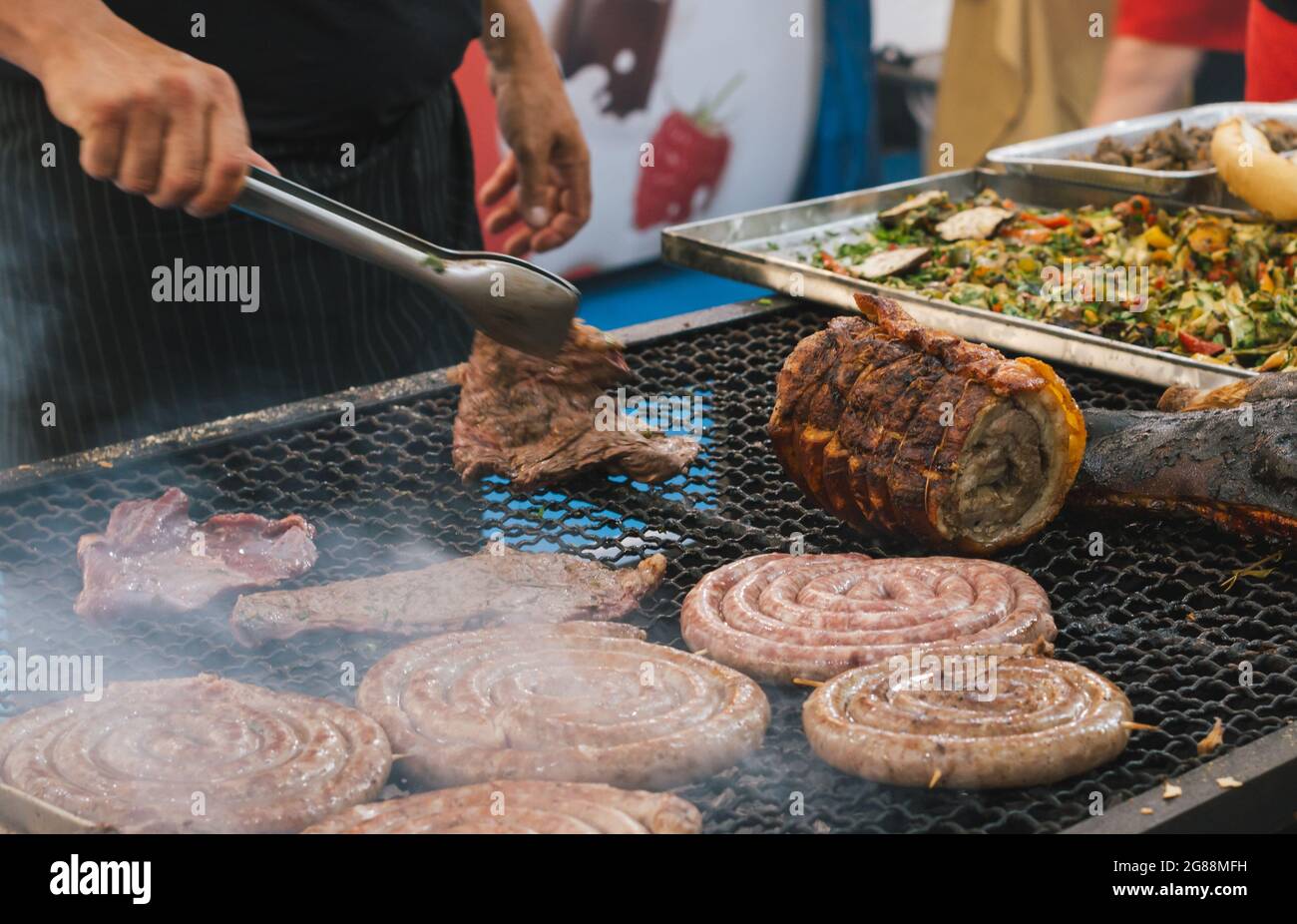 many sausages roasted on the barbeque, pork meat Stock Photo