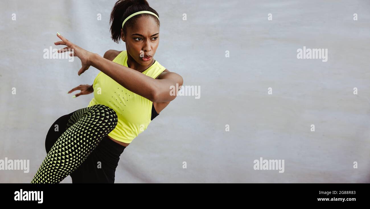 Young African woman doing stretching exercise. Athlete woman doing warm ...