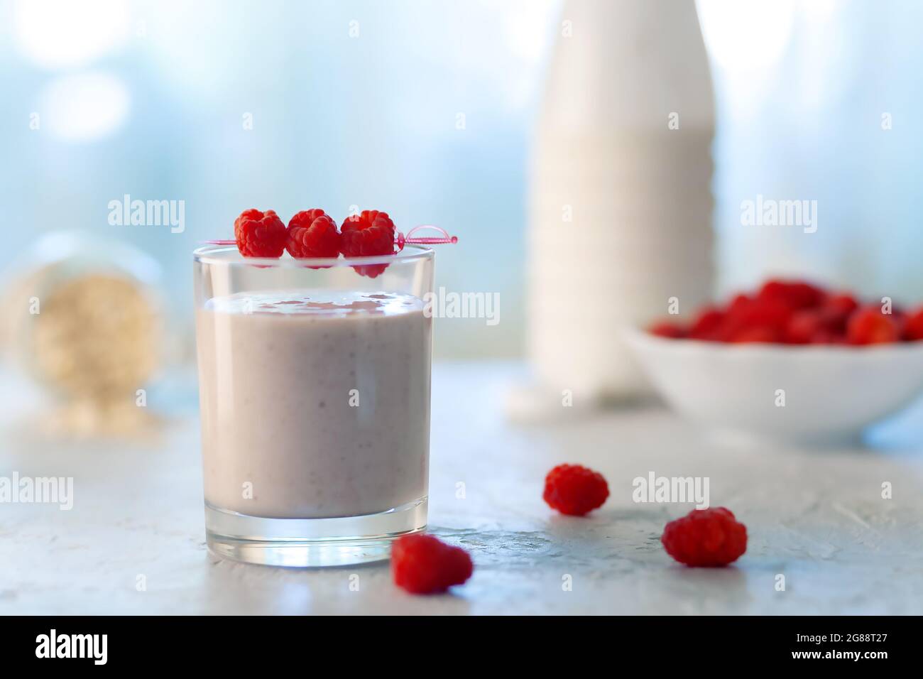 Oatmeal milkshake with bananas and raspberries. Healthy diet food Stock Photo