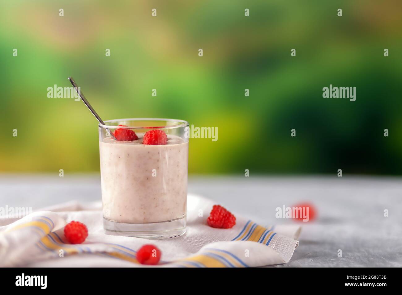 Oatmeal milkshake with bananas and raspberries. Healthy diet food Stock Photo