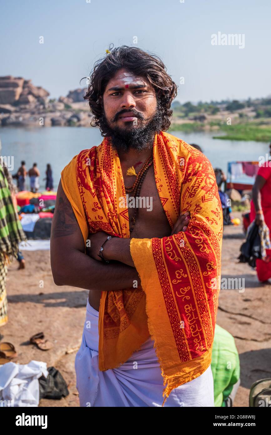 Hampi, Karnataka, India - January 10, 2020 : Local public preparing for worship after bathing in the Tungabhadra in Hampi Town. Stock Photo