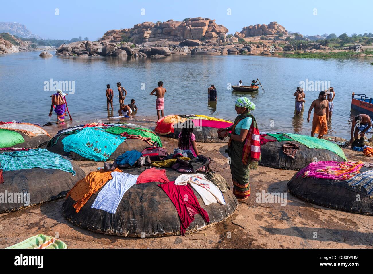 Hampi, Karnataka, India - January 10, 2020 : People bathing and getting ready on the banks of river Tungabhadra in Hampi Town. Stock Photo