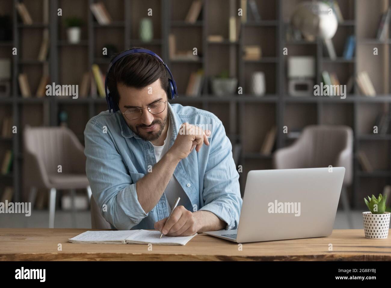 Concentrated attentive young man listening educational lecture Stock ...