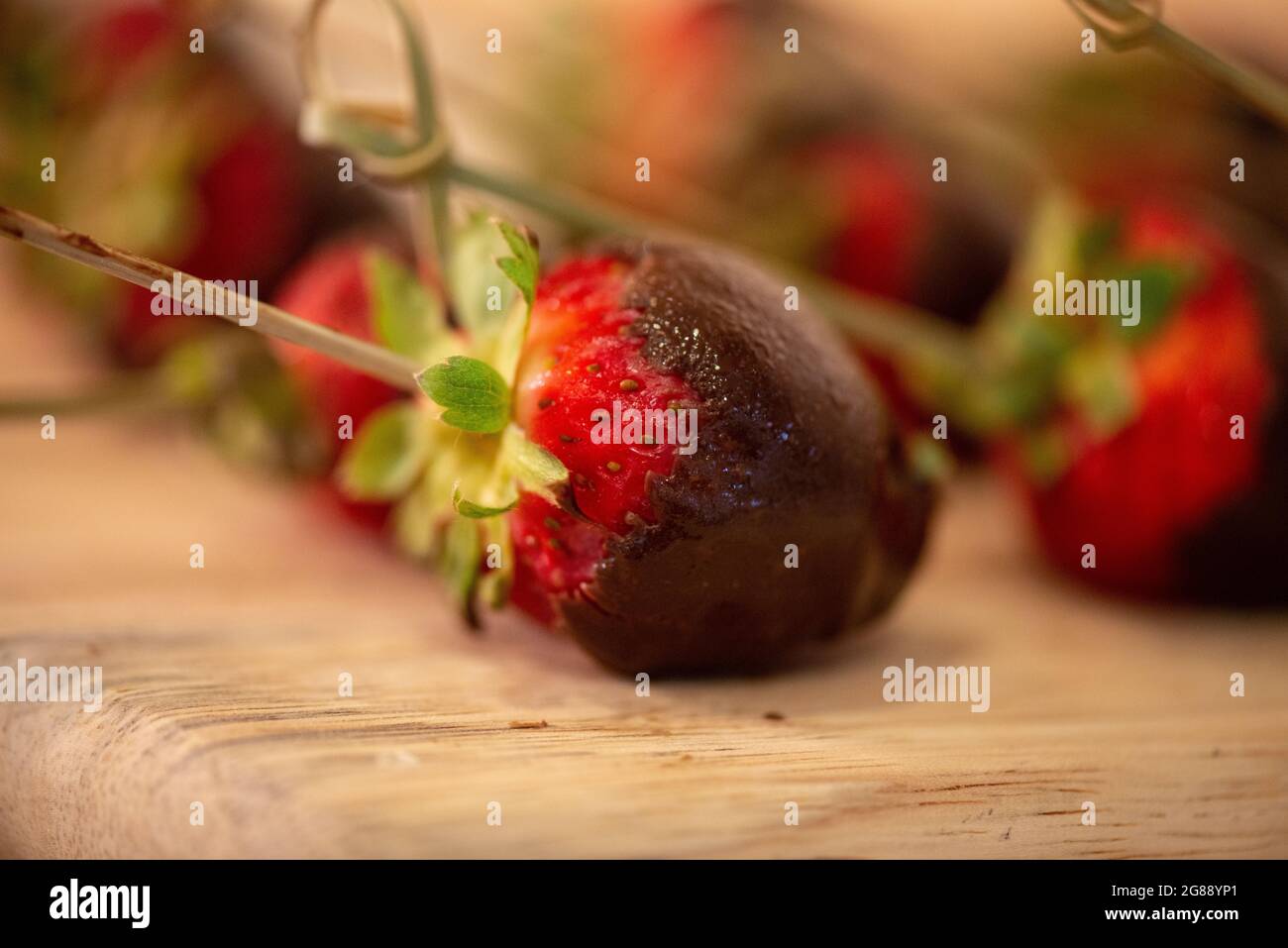 Chocolate Covered Strawberries on  Wood Carving Board Stock Photo