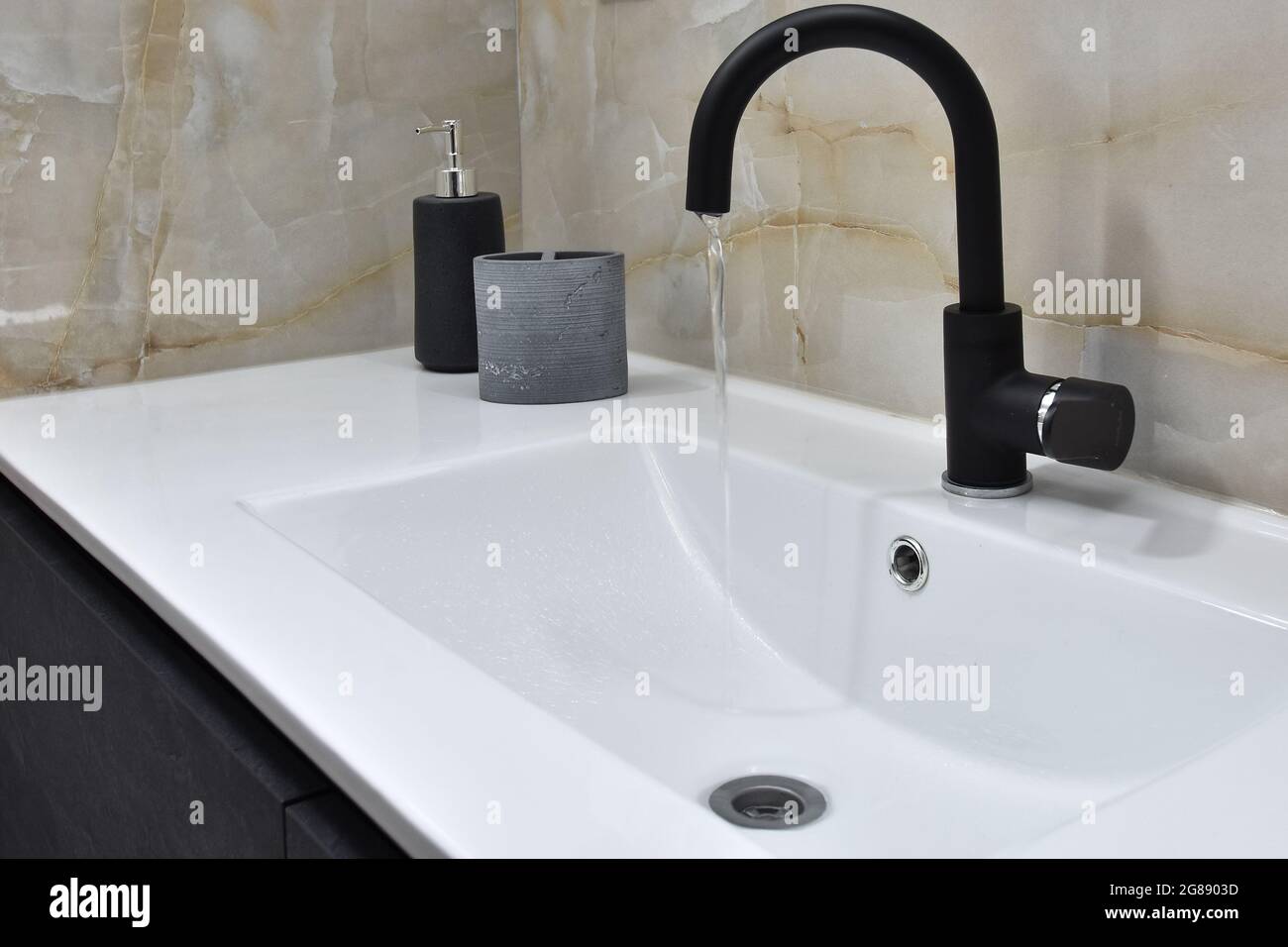 A modern bathroom sink minimalist design, white sink and slow running