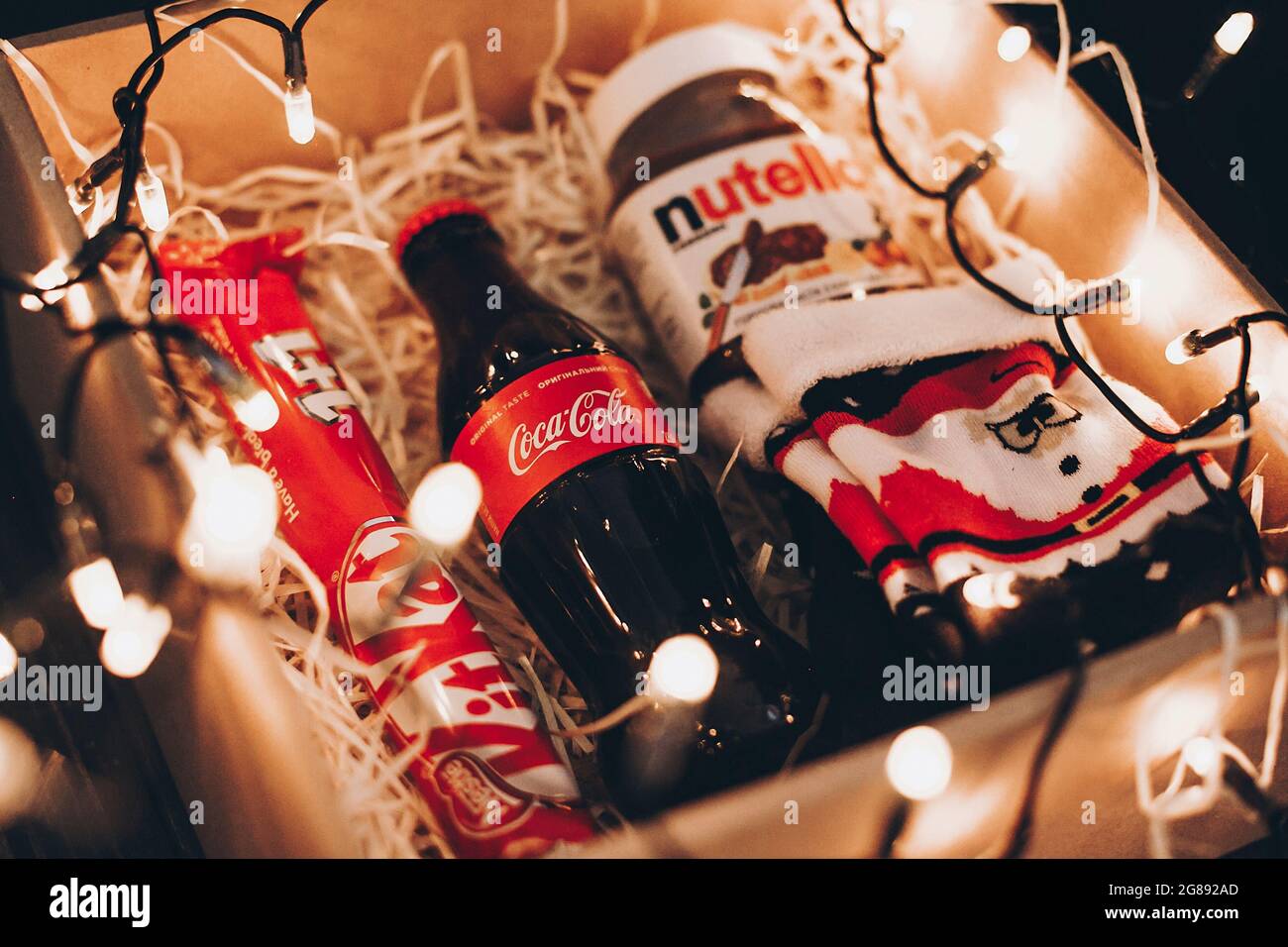 Lviv Ukraine December 1 2017 Coca Cola Bottle Stylish Santa Socks Kit Kat And Nutella On Straw In Gift Box With Christmas Lights Gift Box Fo Stock Photo Alamy