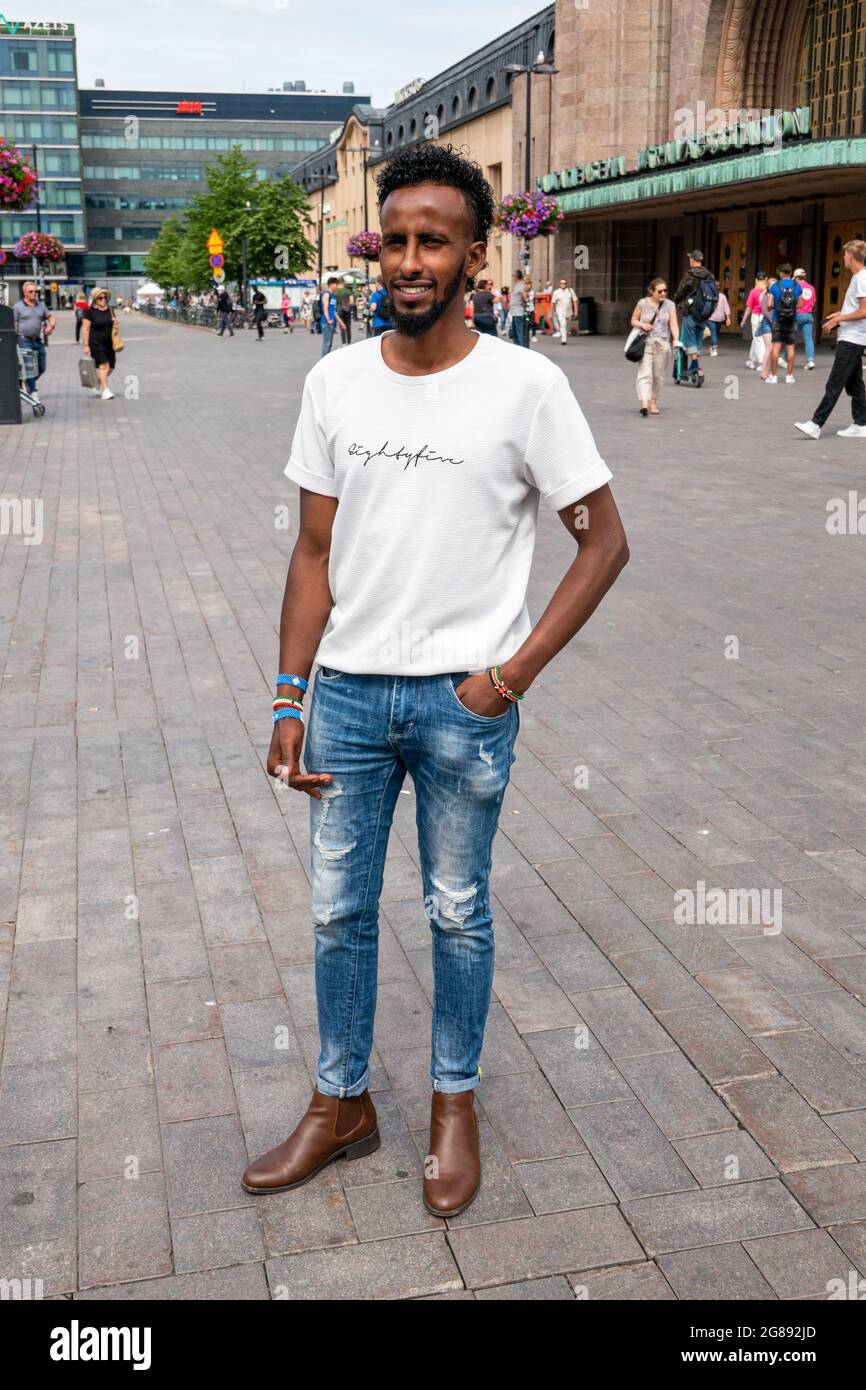 Young African man standing by Central Railway Station in Helsinki, Finland Stock Photo