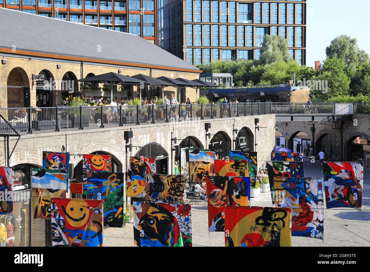 Bethany Williams' flag art installation 'All Our Stories' at Coal Drops Yard, Kings Cross, London, UK Stock Photo