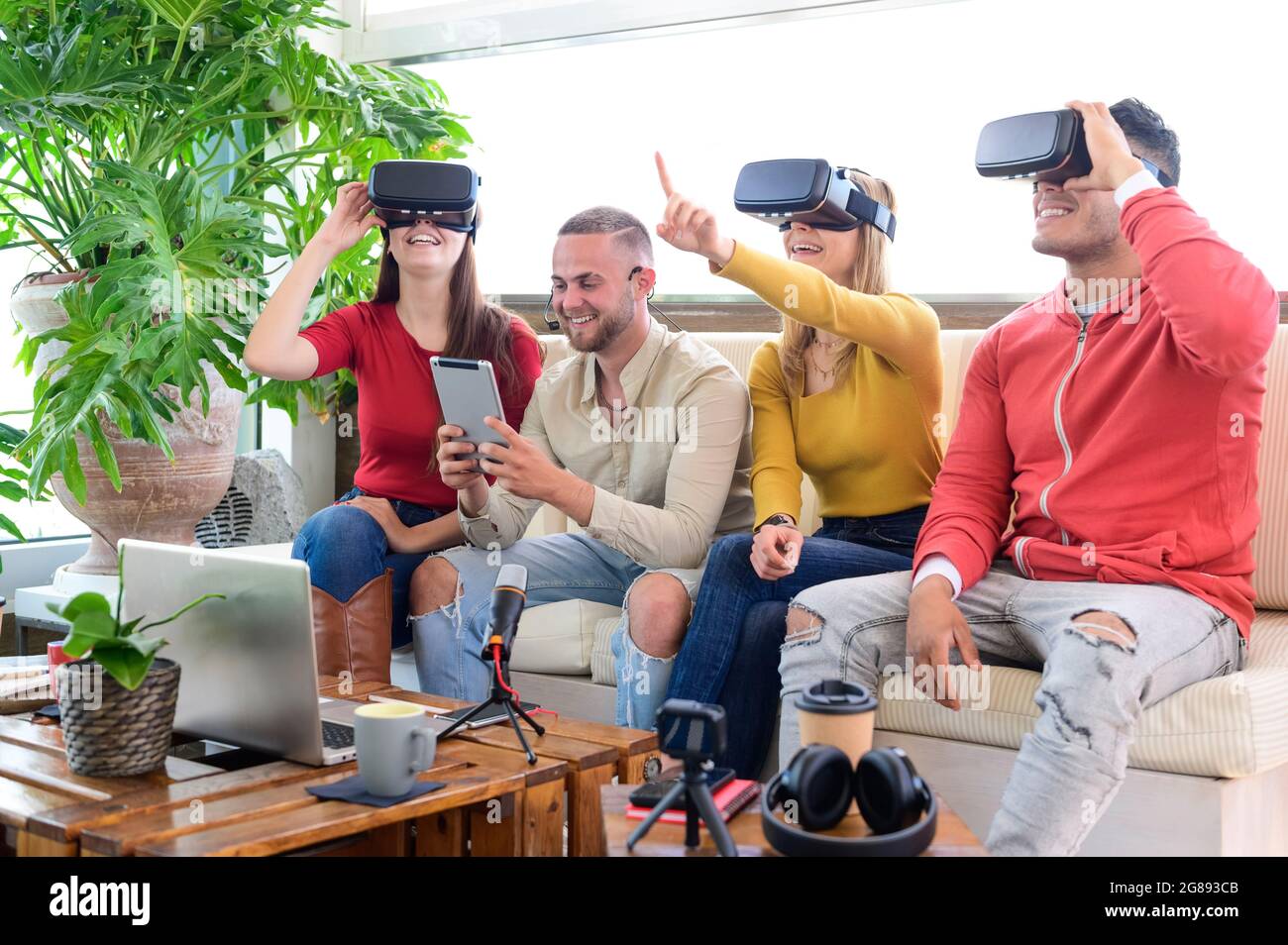 Young people employee workers having fun with vr wearing augmented reality headsets in startup office - High tech office professional people use virtu Stock Photo