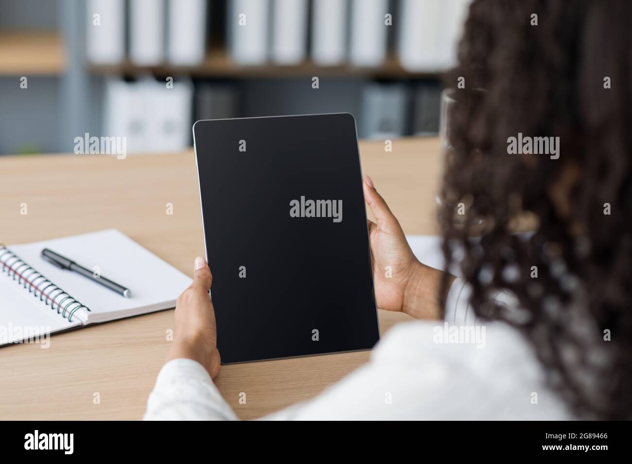 Mockup young business woman using smart tech with screen blank on desk, use device internet for working Stock Photo