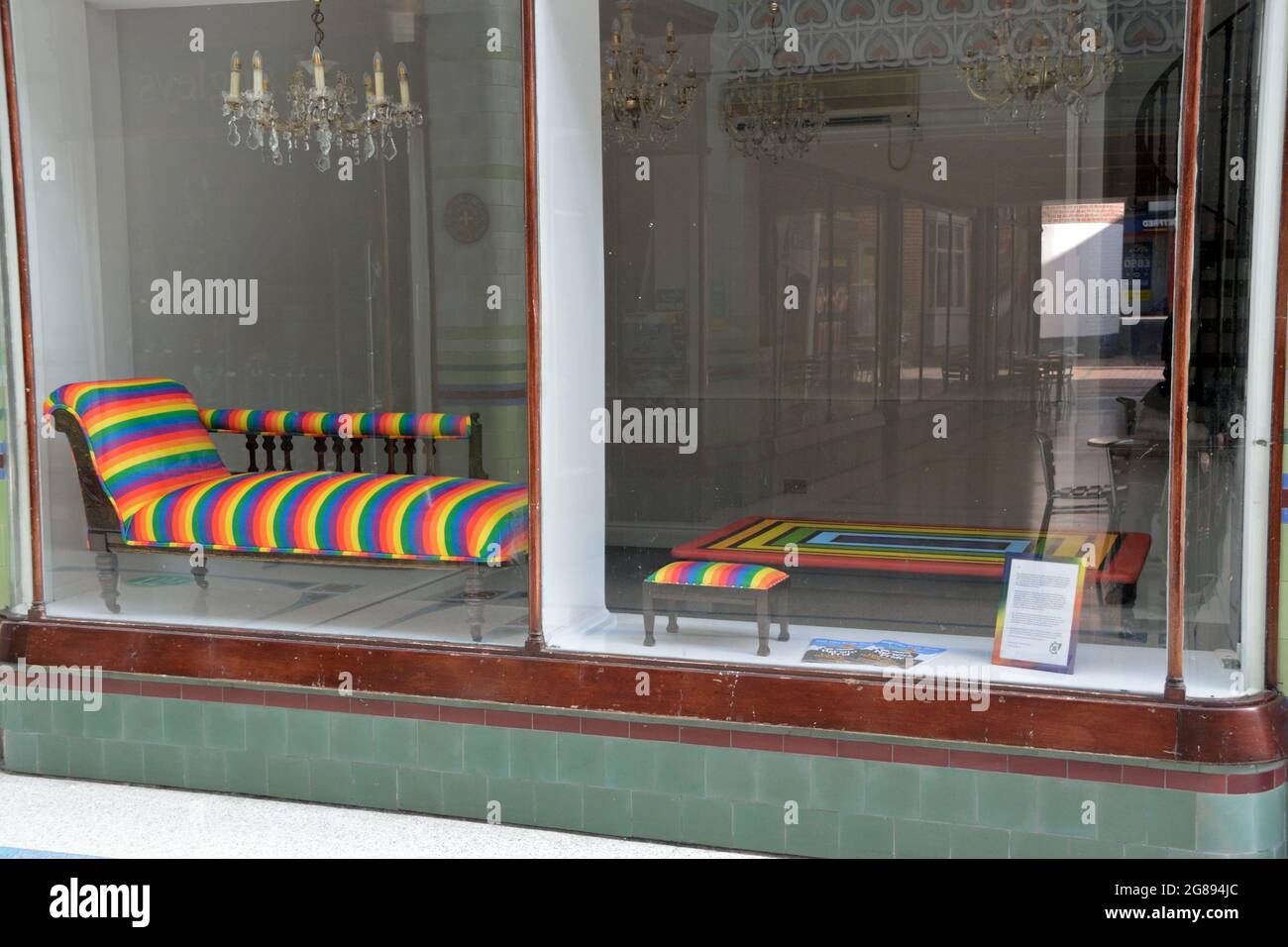 Rainbow furniture on display in shop window, Royal Arcade, Norwich, Norfolk, UK Stock Photo