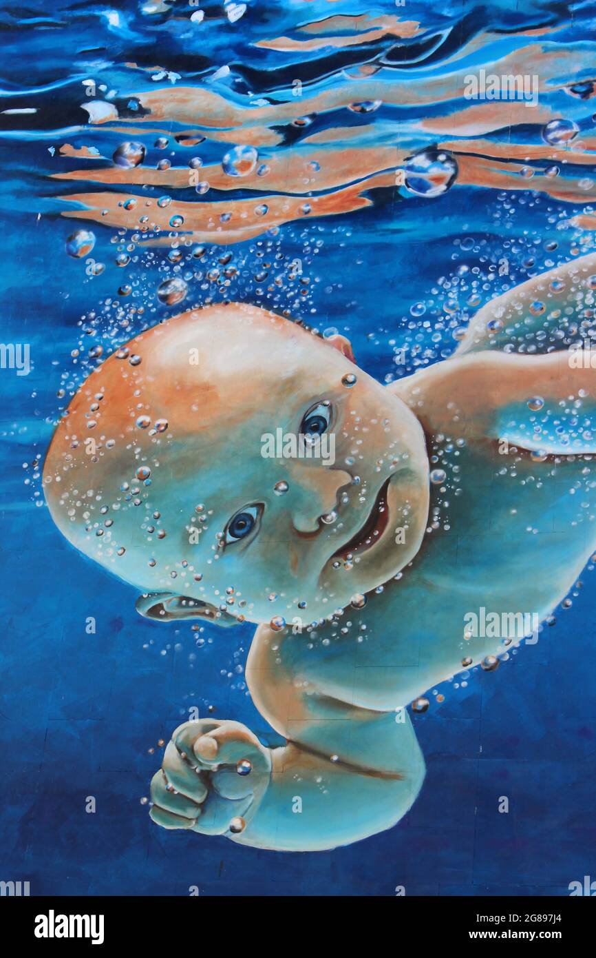 Baby Swimming Underwater - reminiscent of Nirvana's Nevermind Album Cover. Street Art by Paul Curtis - Liverpool's 'new beginnings' post lockdown Stock Photo