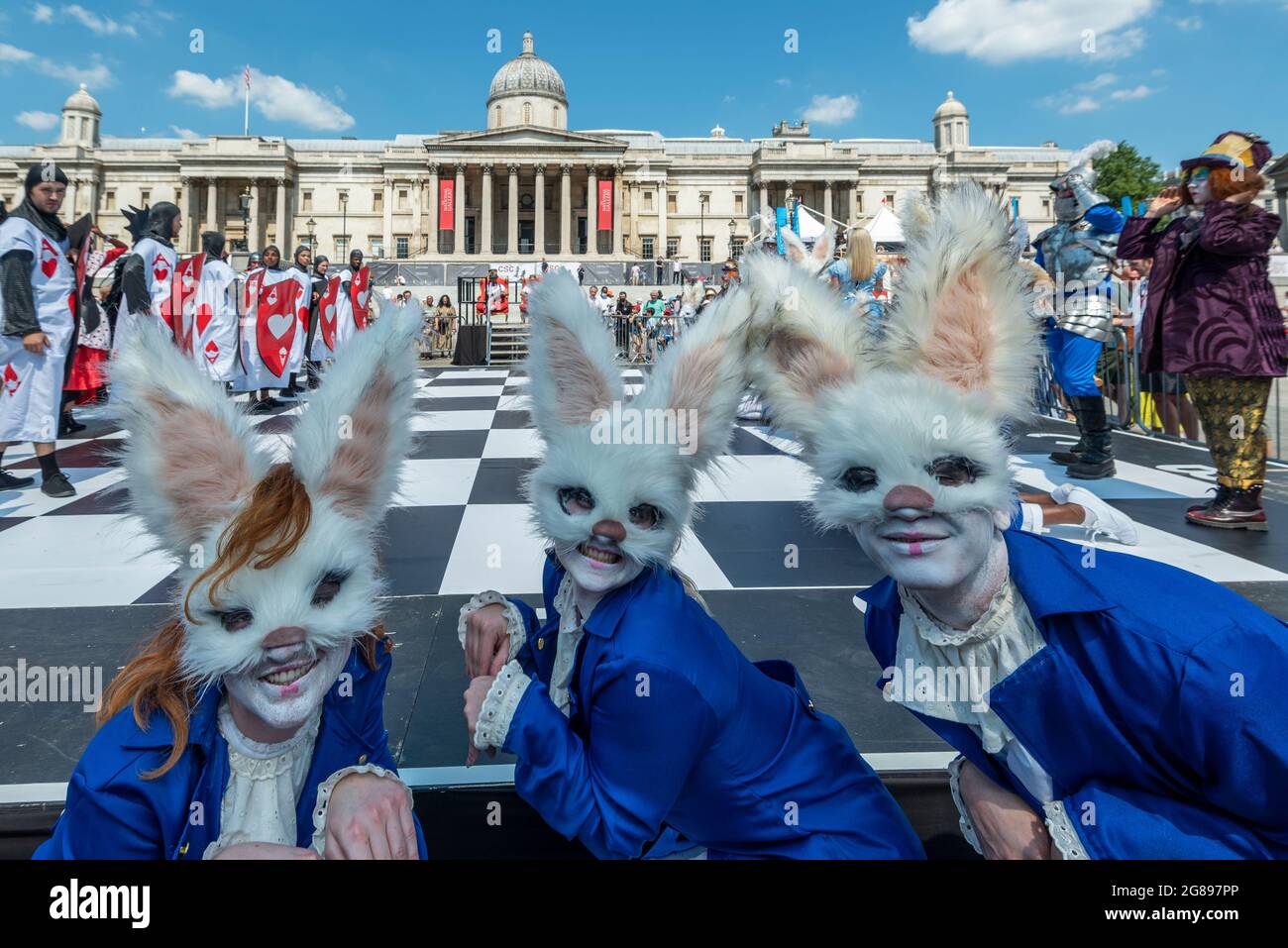 London, UK. 18 July 2021. Actors dressed as white rabbits (as white ...