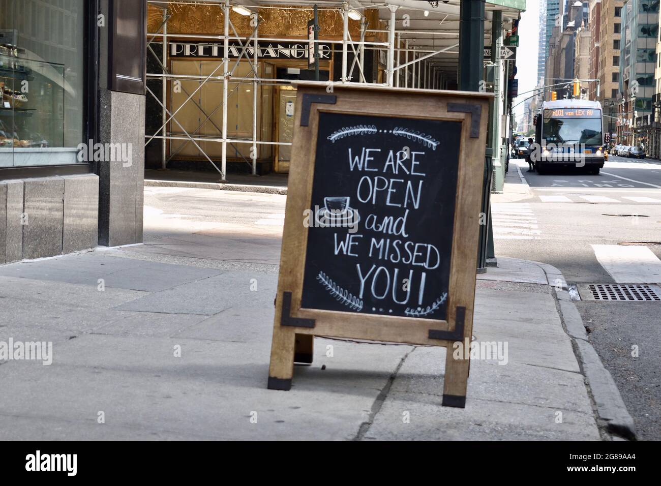 Blackboard sign on a sidewalk reading We Are Open And We Missed You, May 16, 2021, in New York Stock Photo